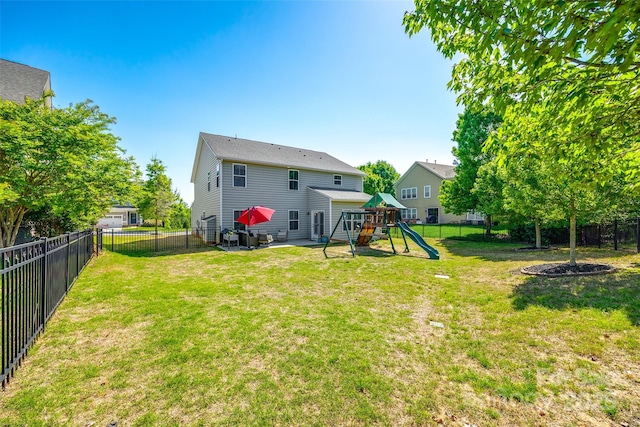 back of house featuring a playground, a patio, a yard, and a fenced backyard