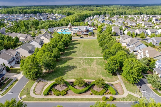 aerial view with a wooded view and a residential view