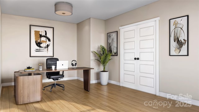 office space featuring light wood-style floors and baseboards