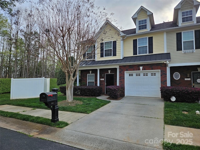 view of front facade with a garage, fence, concrete driveway, and brick siding