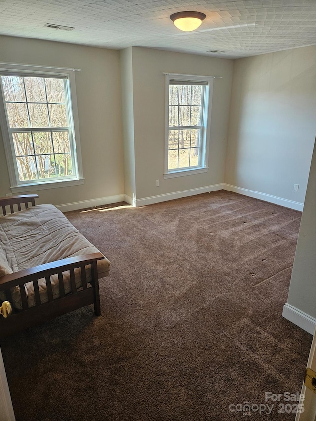 bedroom featuring carpet floors, baseboards, and visible vents