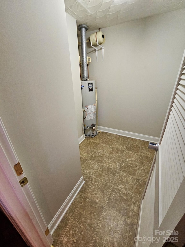 utility room featuring gas water heater