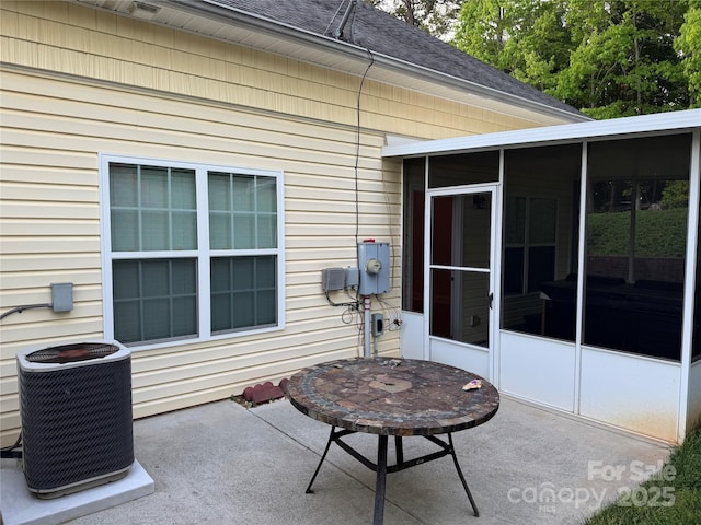 view of patio with a sunroom and cooling unit