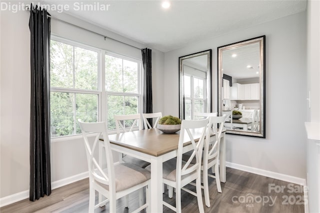 dining space with recessed lighting, baseboards, plenty of natural light, and wood finished floors