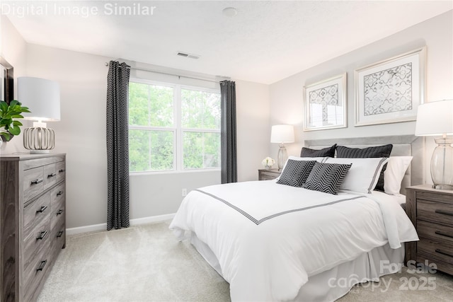 bedroom featuring baseboards, visible vents, and light carpet
