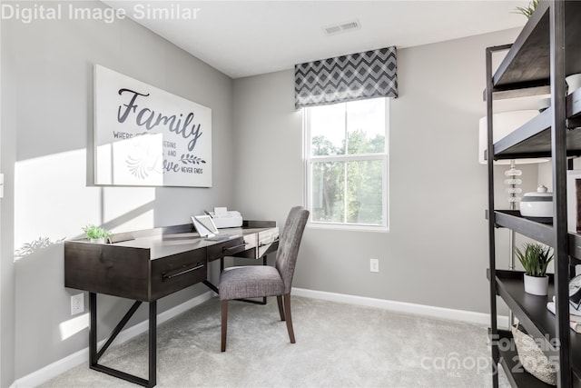 carpeted office featuring visible vents and baseboards