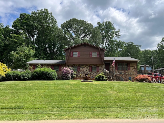 split level home with a front lawn