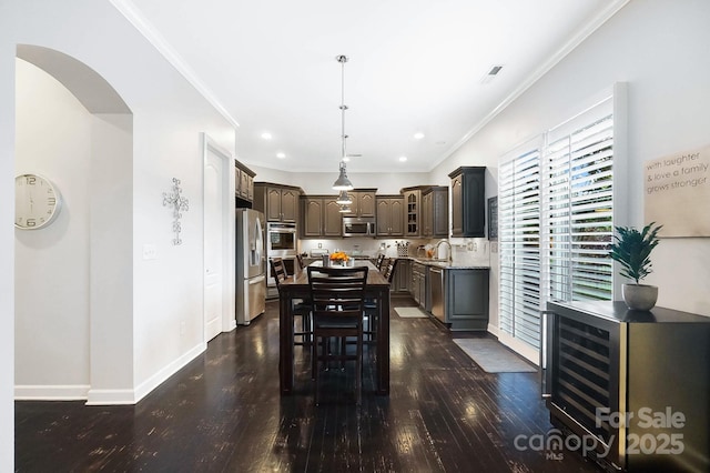 dining area with baseboards, dark wood-style flooring, recessed lighting, and crown molding
