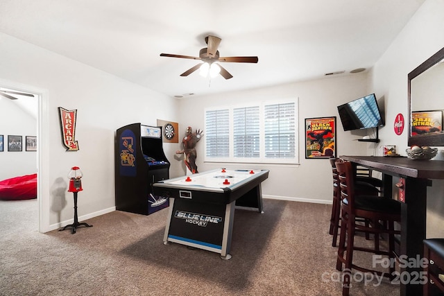 recreation room featuring baseboards, visible vents, ceiling fan, and carpet