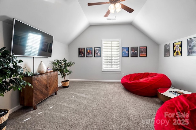 living area with carpet floors, visible vents, baseboards, ceiling fan, and vaulted ceiling