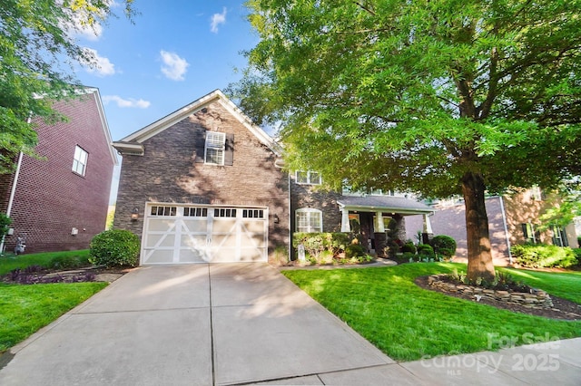 view of front of property featuring driveway, stone siding, a front lawn, and a garage