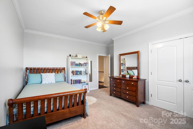 bedroom featuring a closet, crown molding, ceiling fan, carpet flooring, and baseboards