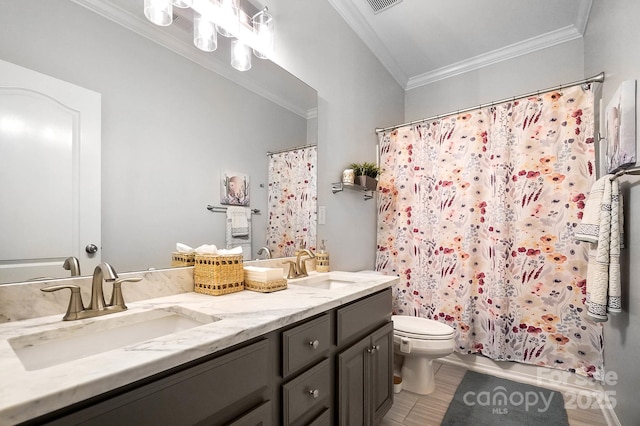 full bath featuring a sink, ornamental molding, and toilet