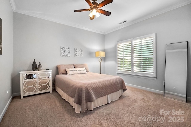 carpeted bedroom with baseboards, ornamental molding, and ceiling fan