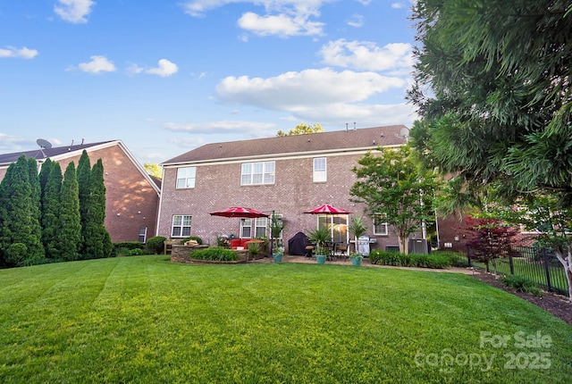 back of property featuring a patio area and brick siding