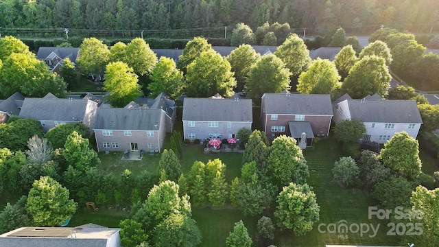 aerial perspective of suburban area with a heavily wooded area