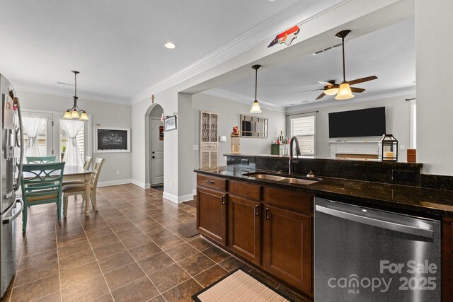1004 Craven St, Indian Trail, NC 28079 - kitchen featuring appliances with stainless steel finishes, a sink, a ceiling fan, arched walkways, and crown molding