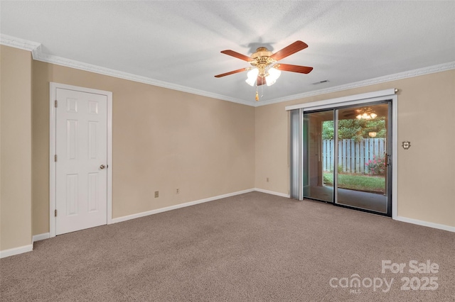 carpeted spare room with crown molding, baseboards, a ceiling fan, and visible vents