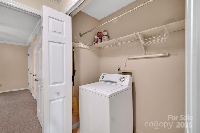 laundry area featuring crown molding, laundry area, carpet floors, baseboards, and washer / dryer