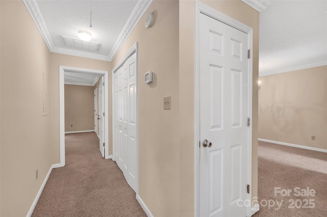 corridor with carpet floors, crown molding, visible vents, baseboards, and a textured ceiling