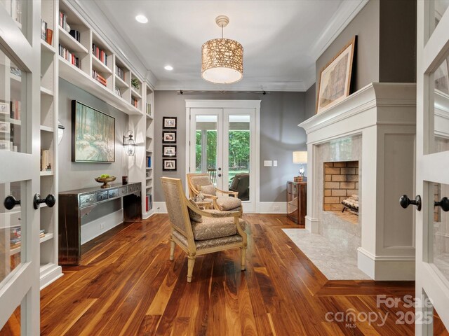 living area with ornamental molding, french doors, recessed lighting, and wood finished floors