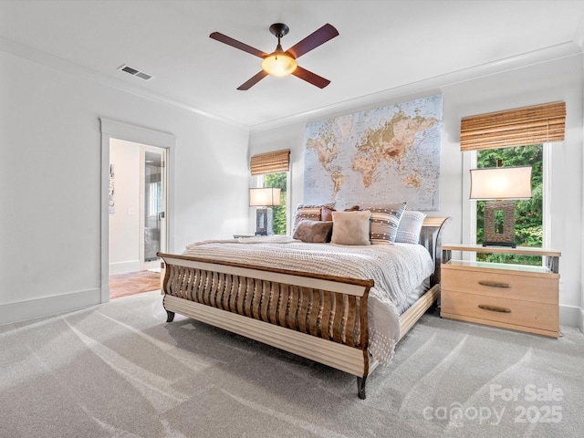 bedroom featuring light colored carpet, a ceiling fan, baseboards, visible vents, and ornamental molding