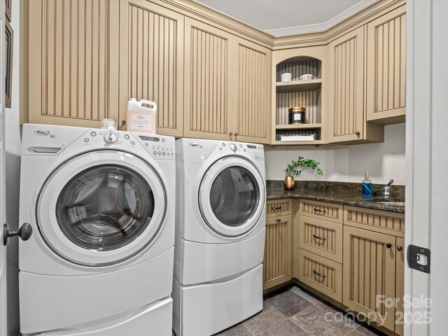 laundry area with washing machine and clothes dryer and cabinet space