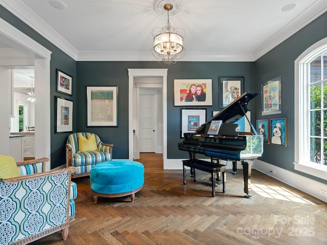 sitting room featuring a healthy amount of sunlight, baseboards, ornamental molding, and a chandelier