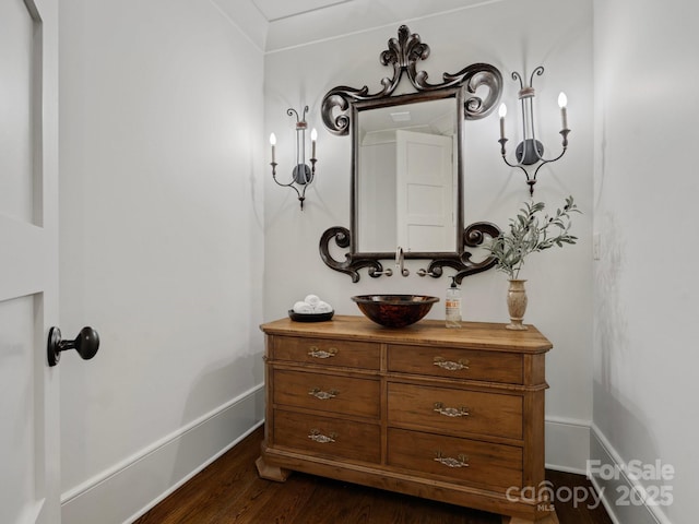 bathroom featuring vanity, baseboards, and wood finished floors