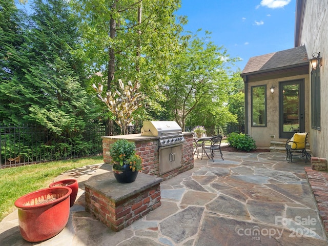 view of patio with fence and area for grilling