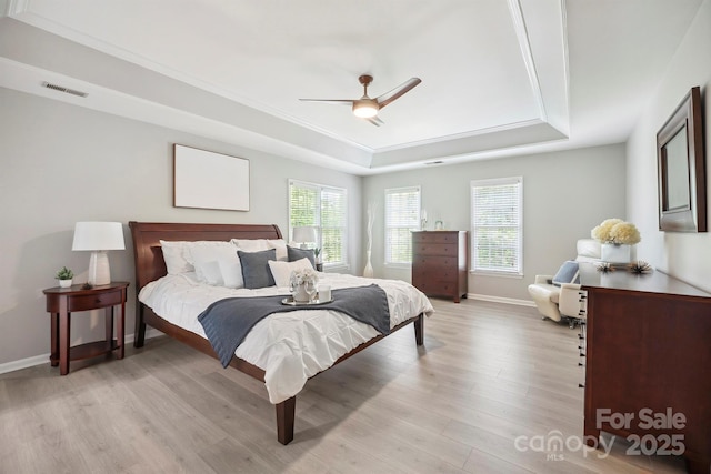 21203 Harken Dr, Cornelius, NC 28031 - bedroom with multiple windows, light wood-type flooring, visible vents, and a raised ceiling