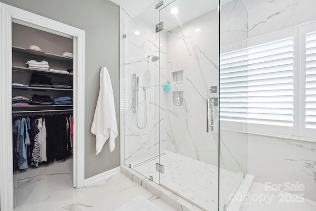 21203 Harken Dr, Cornelius, NC 28031 - full bath featuring a marble finish shower, marble finish floor, baseboards, and a walk in closet