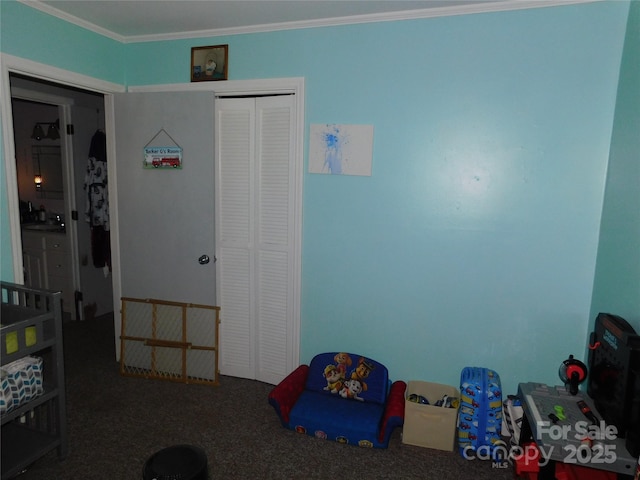 recreation room featuring ornamental molding and carpet flooring