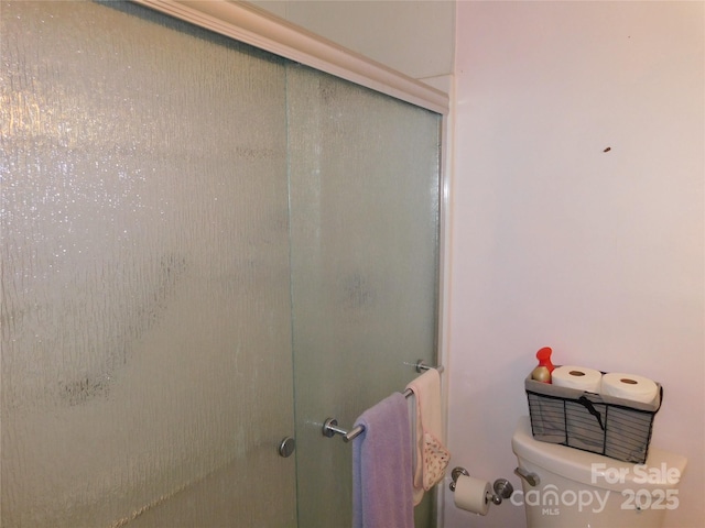 full bathroom with toilet and a shower stall