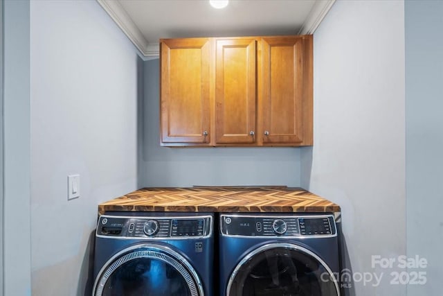 washroom featuring cabinet space and washing machine and dryer
