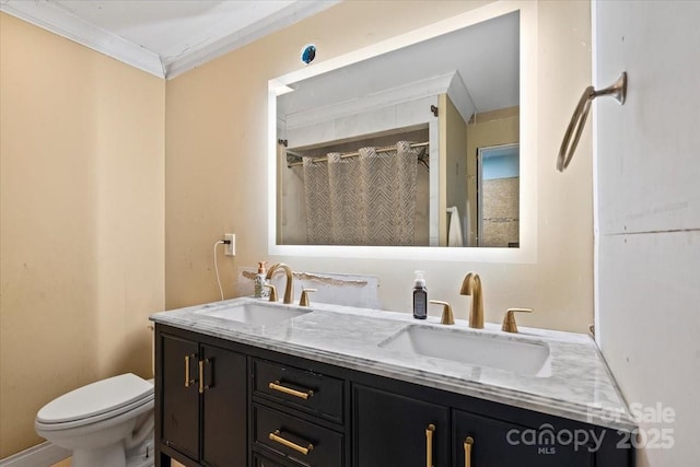 full bath featuring double vanity, toilet, ornamental molding, and a sink