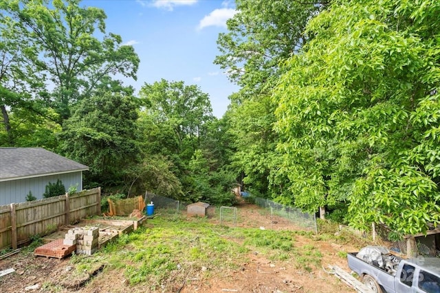 view of yard featuring fence and a garden