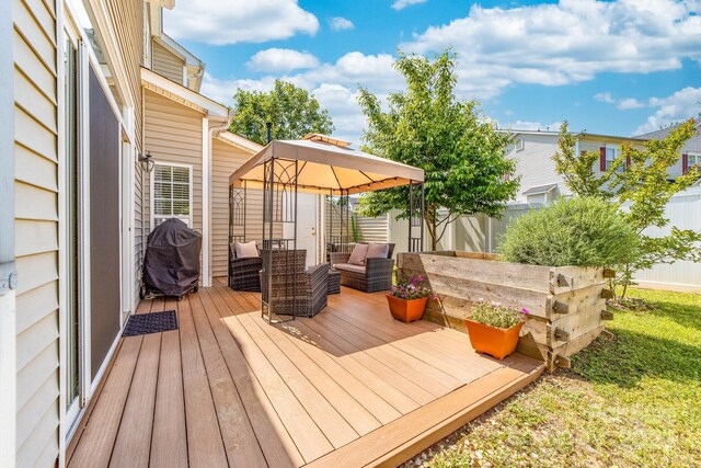 wooden terrace with a gazebo, a fenced backyard, and area for grilling