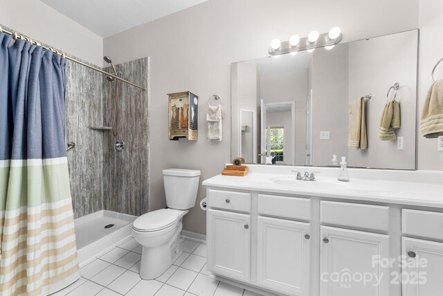 full bath with tile patterned flooring, a tile shower, toilet, and vanity