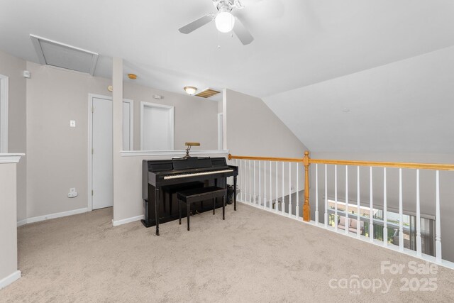 sitting room featuring visible vents, carpet, a ceiling fan, baseboards, and vaulted ceiling