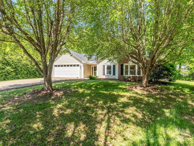 view of front facade featuring a garage, concrete driveway, a front lawn, and brick siding