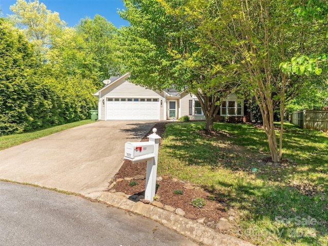 obstructed view of property featuring fence, concrete driveway, a front yard, and a garage