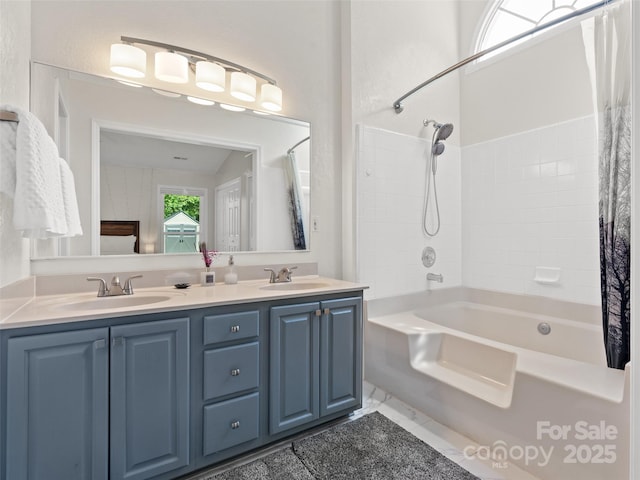 full bathroom featuring double vanity, a sink, and shower / tub combo
