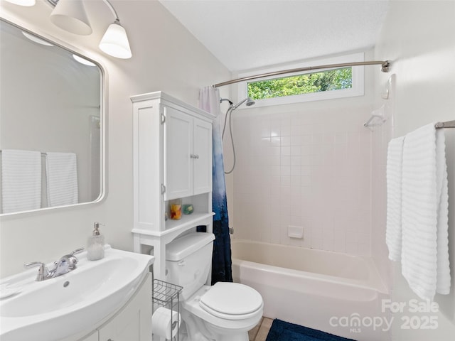 bathroom featuring vanity, shower / bath combination with curtain, and toilet