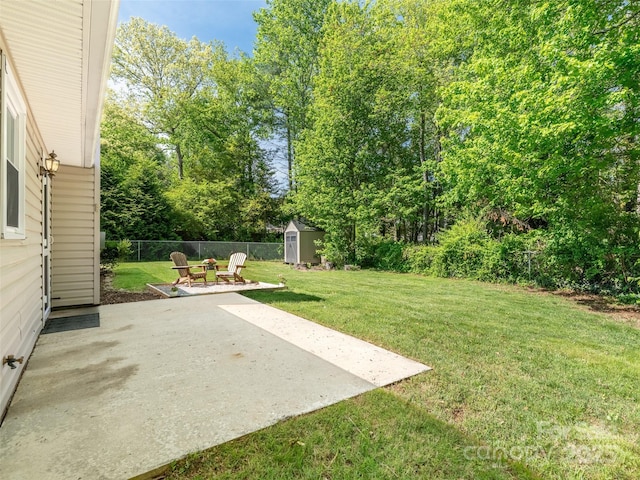 view of yard featuring a storage shed, a patio, an outbuilding, and a fenced backyard