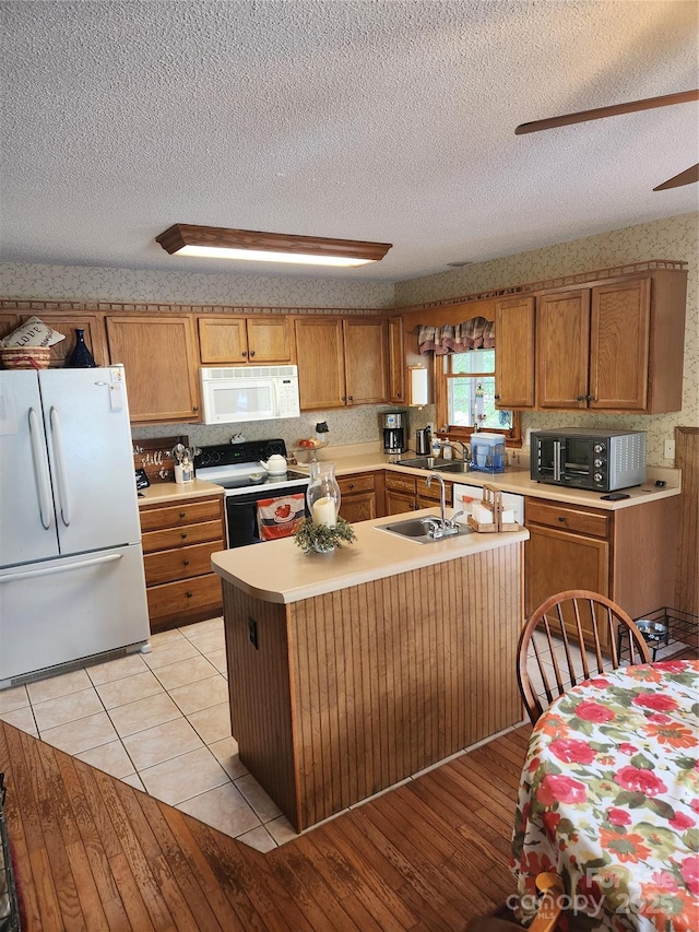 107 Buckner Dr, Roan Mountain, TN 37687 - kitchen with a sink, a textured ceiling, white appliances, and light countertops