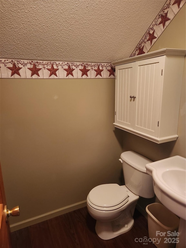 107 Buckner Dr, Roan Mountain, TN 37687 - half bath featuring toilet, a textured ceiling, and wood finished floors
