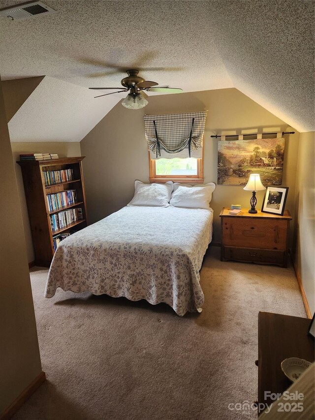 107 Buckner Dr, Roan Mountain, TN 37687 - carpeted bedroom featuring ceiling fan, vaulted ceiling, a textured ceiling, and visible vents