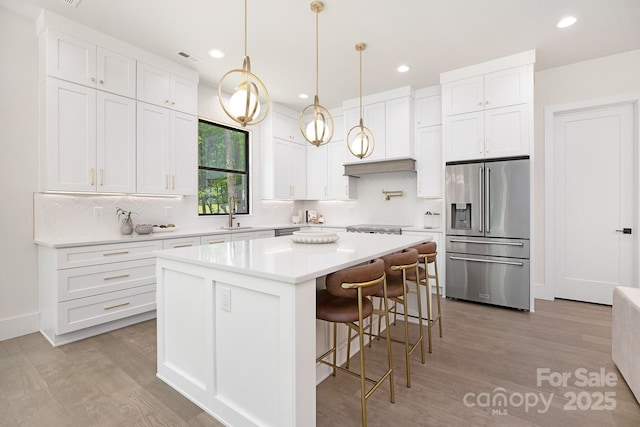 1534 Easy St, Belmont, NC 28012 - kitchen with stainless steel appliances, decorative backsplash, a kitchen island, white cabinets, and recessed lighting