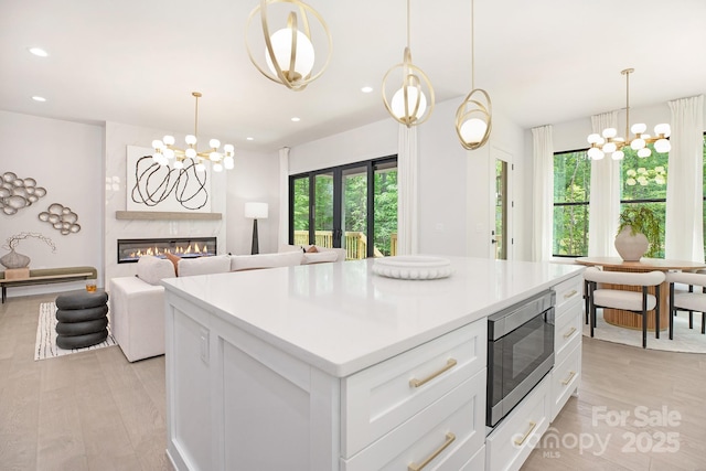 1534 Easy St, Belmont, NC 28012 - kitchen featuring stainless steel microwave, a chandelier, light wood-type flooring, and recessed lighting